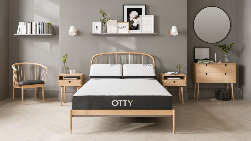 Otty Original Hybrid mattress on a wooden bed frame in a bedroom