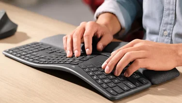 Logitech K860 being used on a wooden desk
