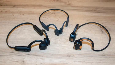 A group of three pairs of bone conduction headphones