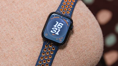 Apple Watch Series 9 against orange background, close up