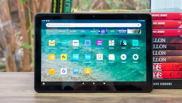 Amazon Fire HD 10 (2023) review - Tablet with screen on leaning on a pile of comic books landscape
