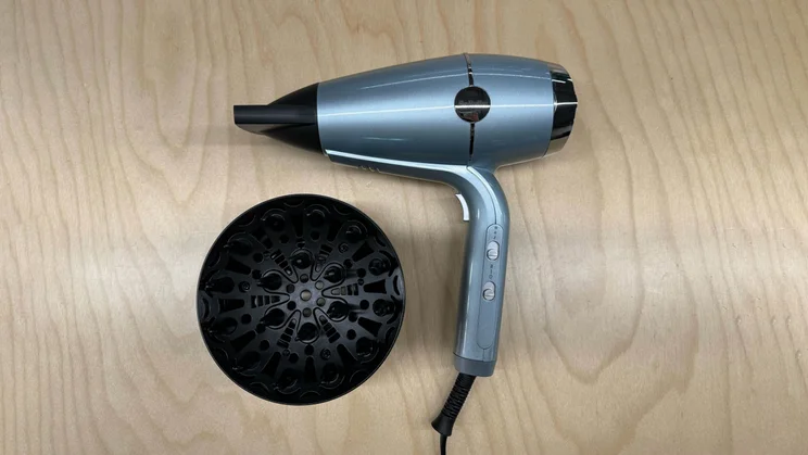 Best hair dryer BaByliss Hydro fusion hair dryer with concentrator nozzle and diffuser photographed on a wooden table