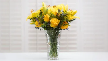 A bouquet of yellow flowers on a white table