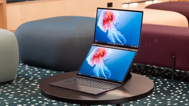 The Asus Zenbook Duo (2024, UX8406) in laptop mode on a black coffee table