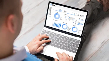 Person using CRM software on laptop