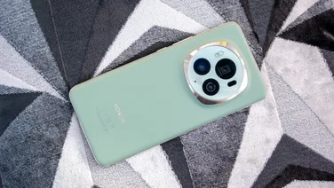 Honor Magic 6 Pro, rear view, sitting on a greyscale geometric pattern cushion