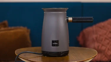 hotel chocolat velvetiser in grey on a wooden table facing front