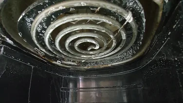 Close up of dirty air fryer heating element inside air fryer.