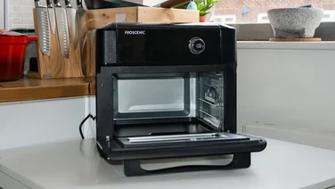 Proscenic T31 Air Fryer Oven on kitchen counter, angled view, opened