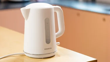 Image of a white kettle on a counter with a blurred background