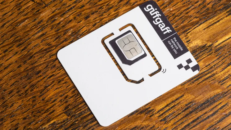 White Giffgaff SIM card on a wooden table