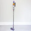 dyson v15 detect absolute in purple on a cream wallpaper background