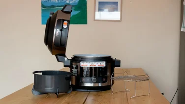 A picture of the Ninja Foodi 11-in-1 SmartLid on a wooden tabletop