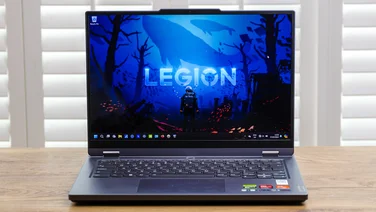 Lenovo Legion on desk with white blinds behind