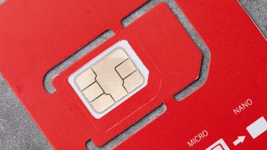 A close up image of a red SIM card