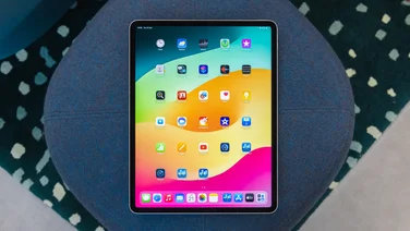 apple ipad air 13 review - tablet with home screen showing on blue sofa