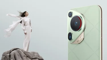 Close up of the green Huawei Pura 70 Ultra with the pop-out camera extended, next to a woman in white standing on a rock