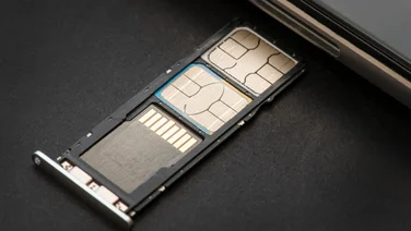 What is dual SIM - featured. SIM tray with an SD card and two SIM cards pulled out of phone