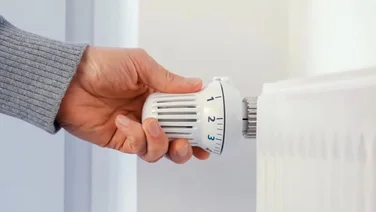 hand adjusting radiator dial - how to drain a central heating system