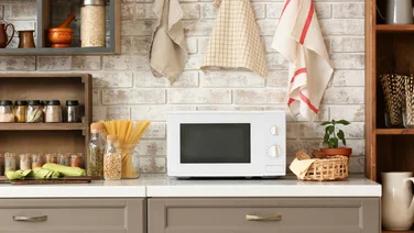 white microwave in modern kitchen - air fryers vs microwaves