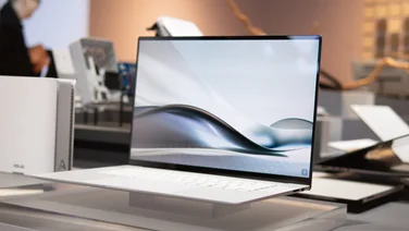 The Asus Zenbook S 16 open, pictured on a display stand at Asus HQ in Tapei