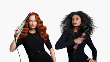 Two women with different hair textures using the curling and diffusing attachments for the new Dyson Airwrap i.d.