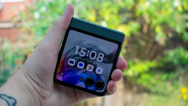 Motorola Razr 50 folded in hand, with the external display on