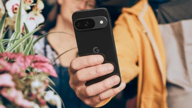 Google Pixel 9, in hand, showing the rear with camera bar and Google logo