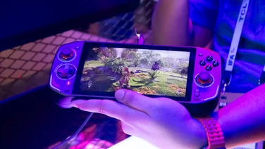 Acer Nitro 7 in hand with a game showing on the display