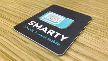 A Smarty SIM card on a wooden table