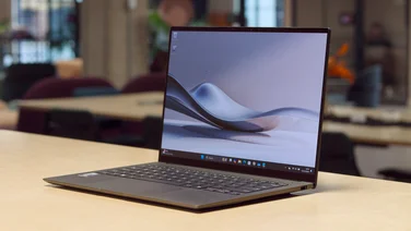 Asus Zenbook S 14 UX5406S on a wood table in an office