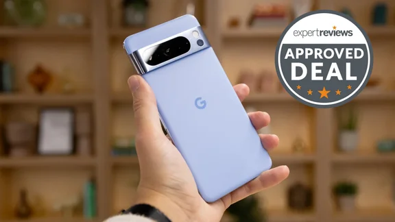 Google Pixel 8 Pro in hand, rear view, in front of some shelving
