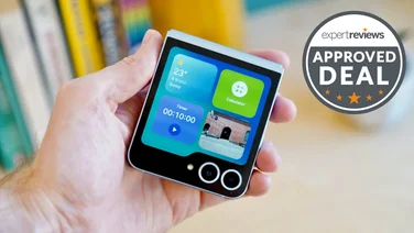 Samsung Galaxy Z Flip 6 folded in hand with the external display on, in front of a bookshelf