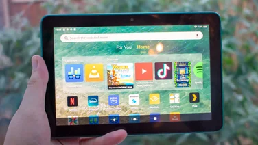 Amazon Fire HD 8 (2024) in hand in front of a window, facing front with the display on