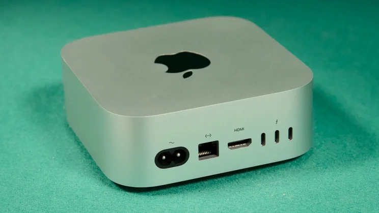 The Mac mini (2024) on a green textile surface