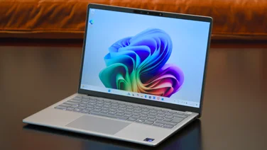 The Dell Inspiron 14 Plus on a coffee table