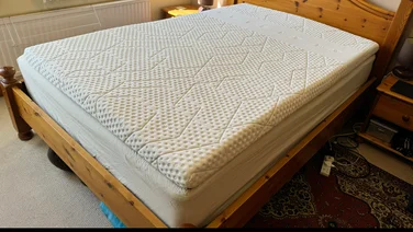 The Emma premium mattress topper on a wood bed frame