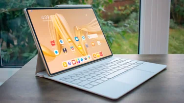 Huawei MatePad Pro (2024) in a keyboard case, sitting on a desk in front of a window with the display on