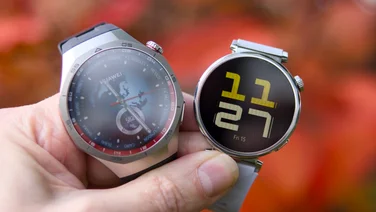 Huawei Watch GT 5 Pro and GT 5 against a red blurred background