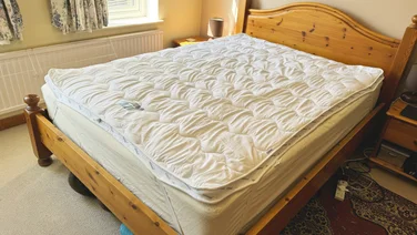 The Silentnight Airmax mattress topper on a wooden bed frame