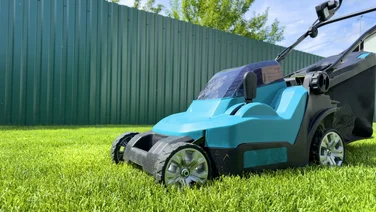 Corded vs cordless lawn mowers header electric mower sitting on a garden