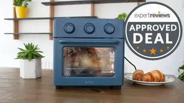 The Our Place Wonder Oven on a wooden countertop overlaid with an Expert Reviews Approved Deal roundal