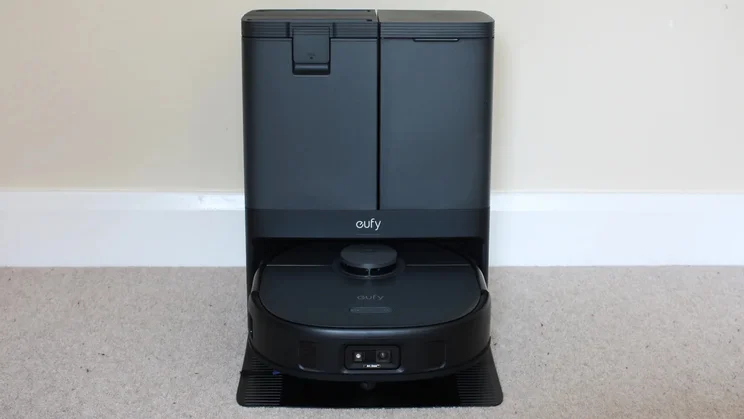 The Eufy Clean X10 Pro Omni in its base station in front a plain white wall