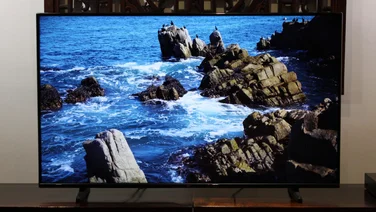 bush_ut24sb_review_featured_image image of the sea and rocks, tv on wooden stand