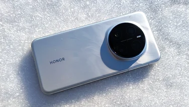 The Honor Magic 7 Pro lying on snow, rear view