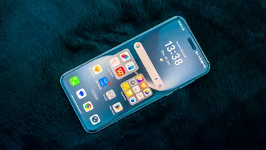 Honor Magic 7 Pro on a black cushion, front view with the display showing the homescreen