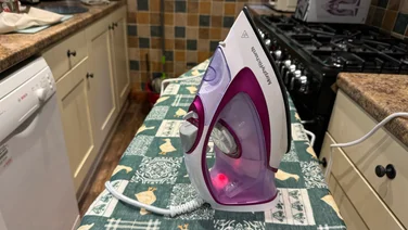 Morphy Richards Turboglide steam iron review teaser on a ironing board with a green patterned cover