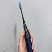 Oclean Flow review - 3 blue toothbrush being held