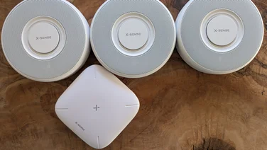 X-Sense XS0B-MR31 smart smoke alarm kit pictured on a wood surface