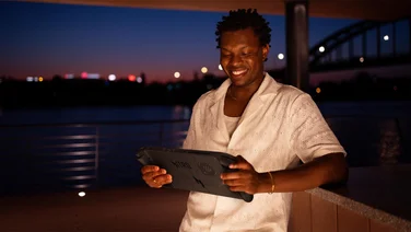 Man holding the Acer Nitro Blaze 11 games console smiling